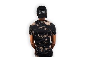 Men wearing a # Jesus survival tee with his back showing while wearing a # Jesus distressed hat.